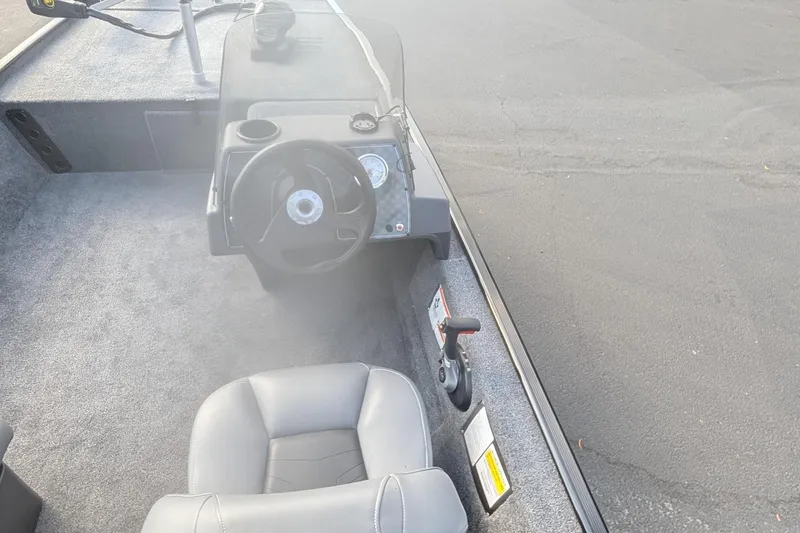 Slide: The Image of Interior view of 2026 Tracker Bass Tracker Classic XL boat cockpit with steering wheel and seat. - 11