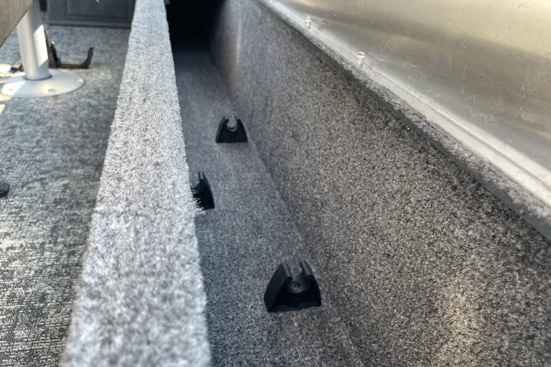 Slide: The Image of Interior view of 2026 Tracker Pro Guide V-16 WT boat with carpeted storage compartment. - 14