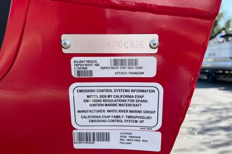Slide: The Image of 2026 Tracker Pro Guide V-16 WT boat emissions label on red transom. - 26