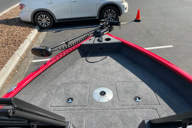 Slide: The Image of 2026 Tracker Pro Guide V-16 WT boat with Minn Kota trolling motor in parking lot. - 18