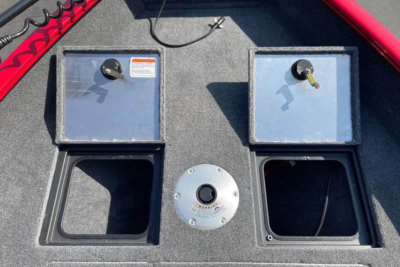 Slide: The Image of 2026 Tracker Pro Guide V-16 WT boat deck with storage compartments and control panel. - 16