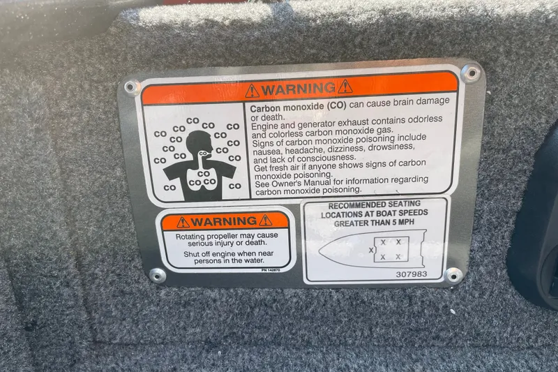 Slide: The Image of Warning labels on 2026 Tracker Pro Guide V-16 WT boat, cautioning about carbon monoxide and propeller safety. - 25