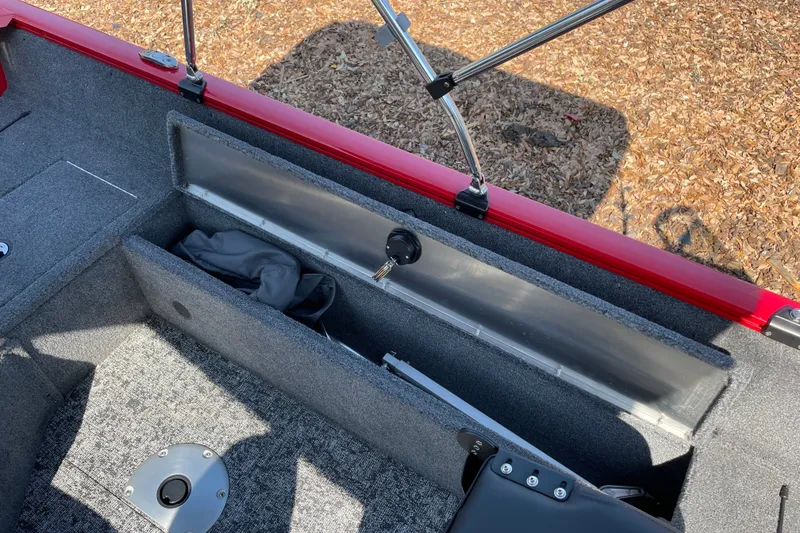 Slide: The Image of Interior view of 2026 Tracker Pro Guide V-16 WT boat with storage compartment open. - 23