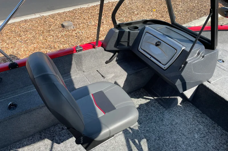 Slide: The Image of 2026 Tracker Pro Guide V-16 WT boat interior with gray seating and storage compartment. - 22