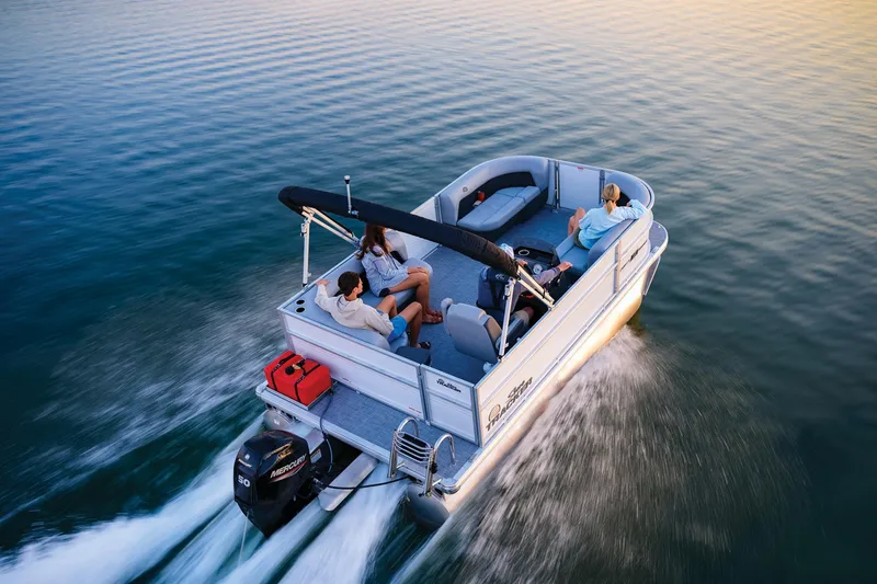 Slide: The Image of 2026 Sun Tracker Party Barge 16 DLX interior with gray seating and modern helm. - 3