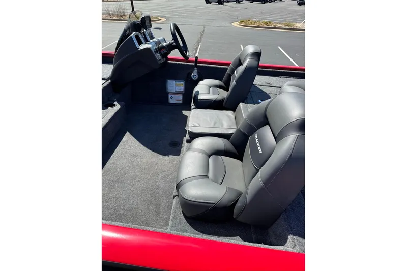 Slide: The Image of 2026 Tracker Pro Team 195 boat interior with gray seating and steering console. - 10