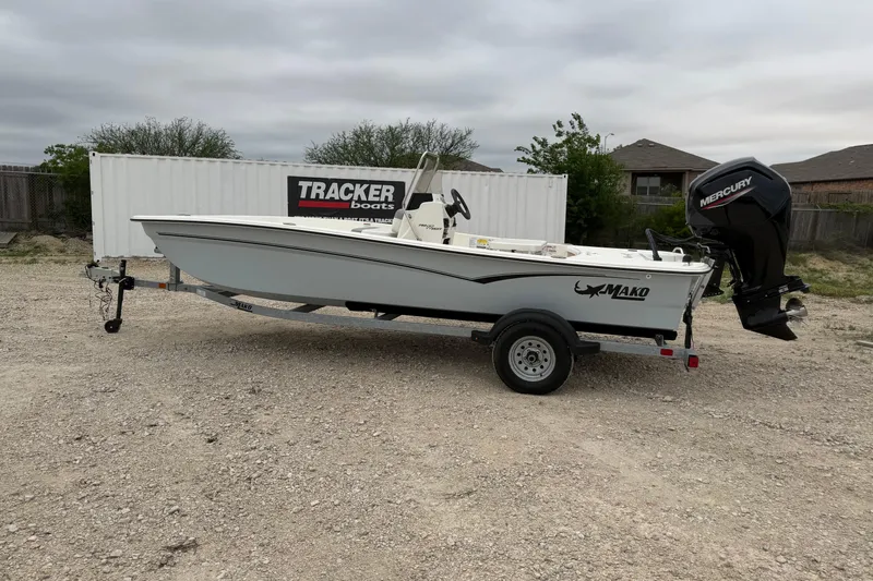 The Image of 2023 Mako Pro Skiff 17 CC boat on trailer, with Mercury outboard motor. - 1