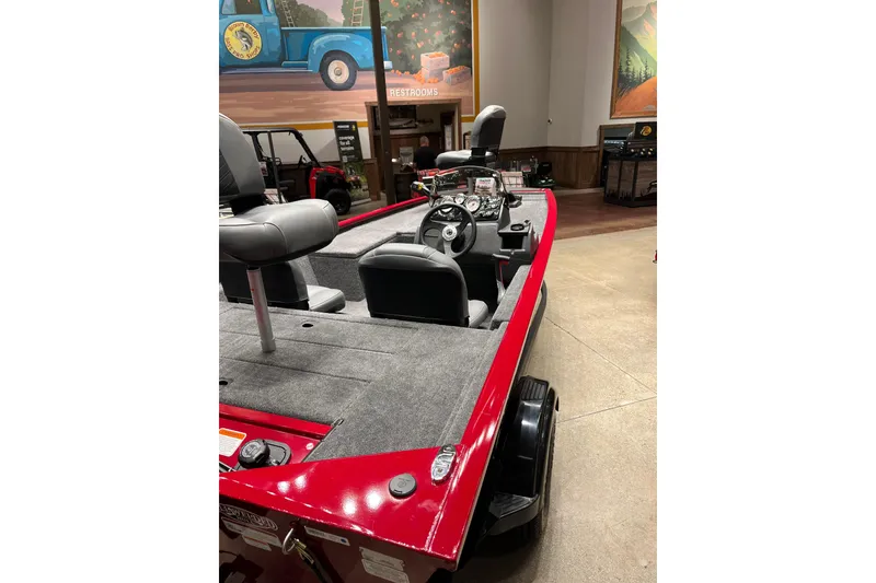 Slide: The Image of 2026 Tracker Pro 170 boat with red exterior and gray interior, displayed indoors. - 4