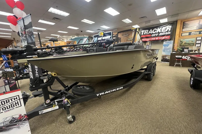 The Image of 2026 Tracker Targa V-19 Combo boat displayed in showroom with promotional materials. - 0