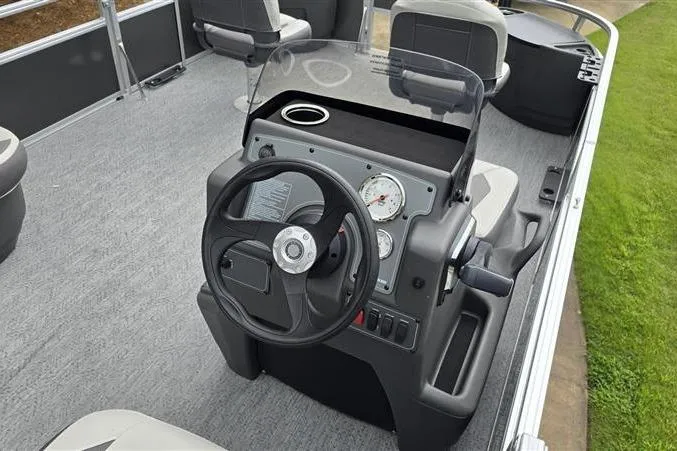 Slide: The Image of 2026 Sun Tracker Bass Buggy 18 DLX boat dashboard with steering wheel and gauges. - 7