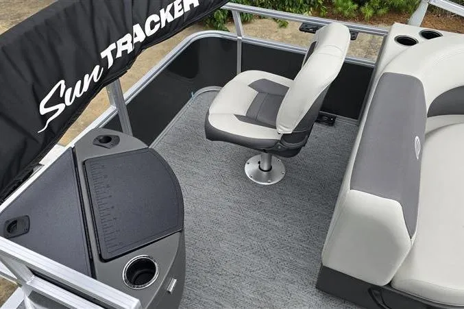 Slide: The Image of 2026 Sun Tracker Bass Buggy 18 DLX interior with seating and console, showcasing modern design. - 10