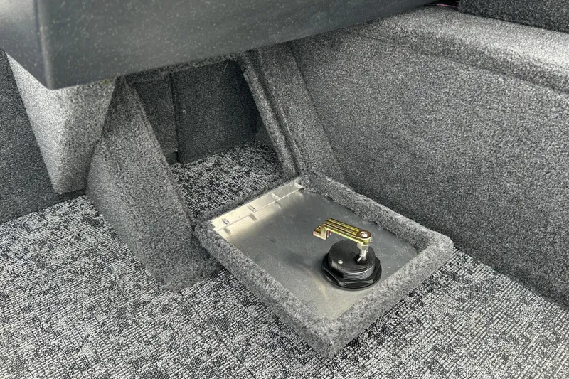 Slide: The Image of 2026 Tracker Pro Guide V-16 WT interior detail with carpeted flooring and storage compartment. - 17