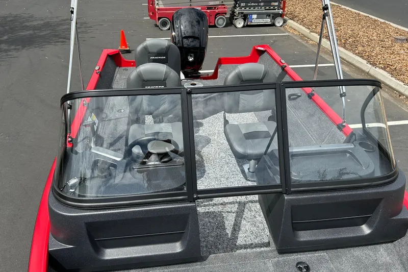 Slide: The Image of 2026 Tracker Pro Guide V-16 WT boat with windshield and seating, parked outdoors. - 21