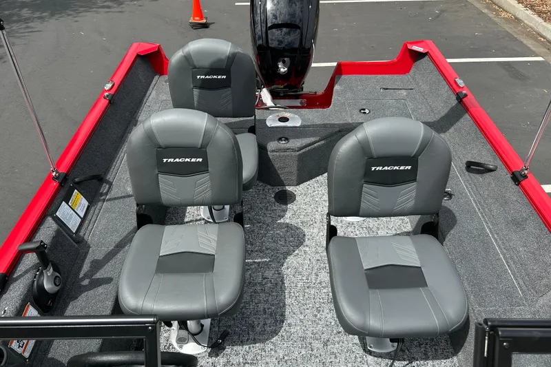 Slide: The Image of 2026 Tracker Pro Guide V-16 WT boat interior with four gray seats and red accents. - 22