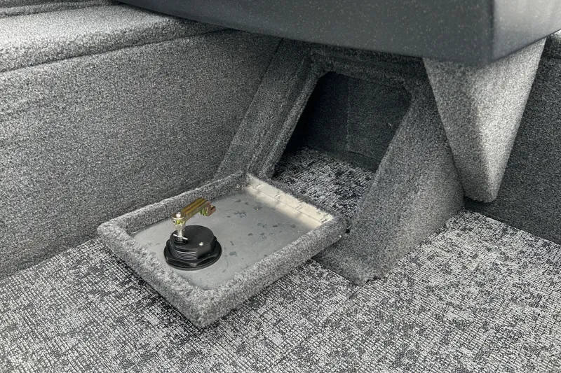 Slide: The Image of Interior view of 2026 Tracker Pro Guide V-16 WT boat, featuring carpeted flooring and storage compartment. - 16