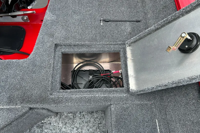 Slide: The Image of 2026 Tracker Pro Guide V-16 WT boat interior storage compartment with cables. - 12