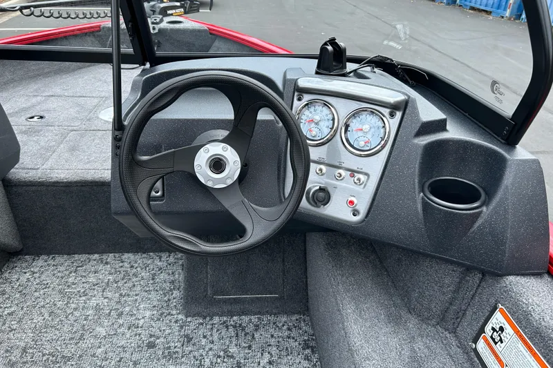 Slide: The Image of Steering console of 2026 Tracker Pro Guide V-16 WT boat with gauges and controls. - 5