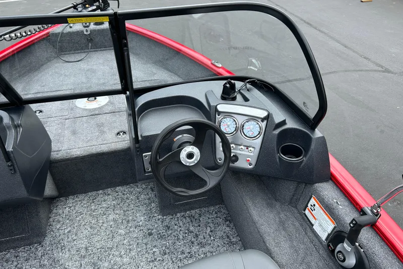 Slide: The Image of 2026 Tracker Pro Guide V-16 WT boat interior with steering wheel and dashboard controls. - 4