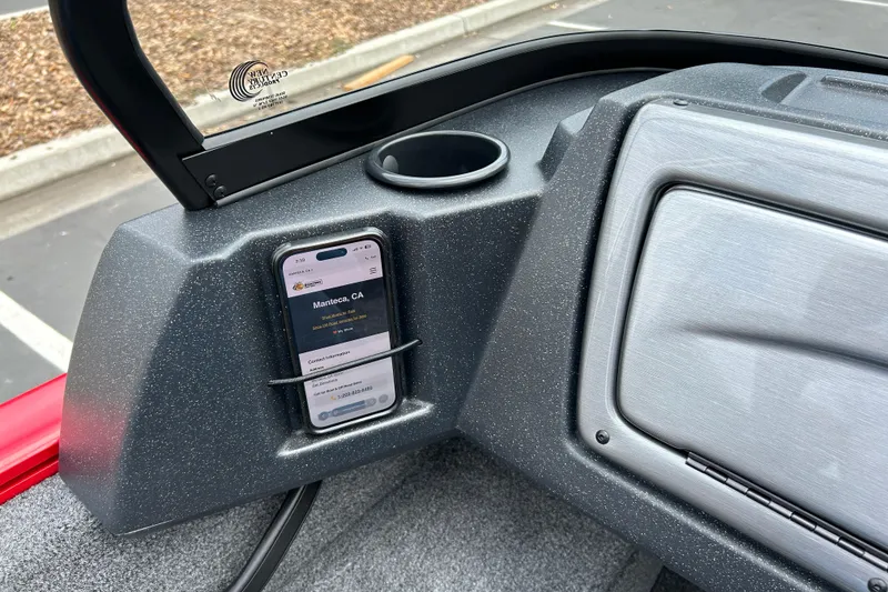 Slide: The Image of 2026 Tracker Pro Guide V-16 WT dashboard with phone holder and cup holder. - 9
