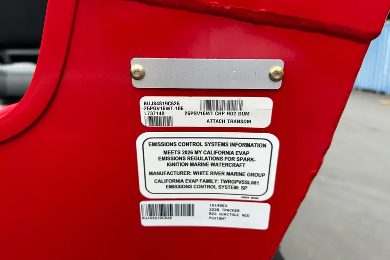 Slide: The Image of 2026 Tracker Pro Guide V-16 WT emissions label on red surface, detailing compliance information. - 68