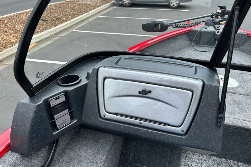 Slide: The Image of 2026 Tracker Pro Guide V-16 WT boat dashboard with storage compartment and phone holder. - 10