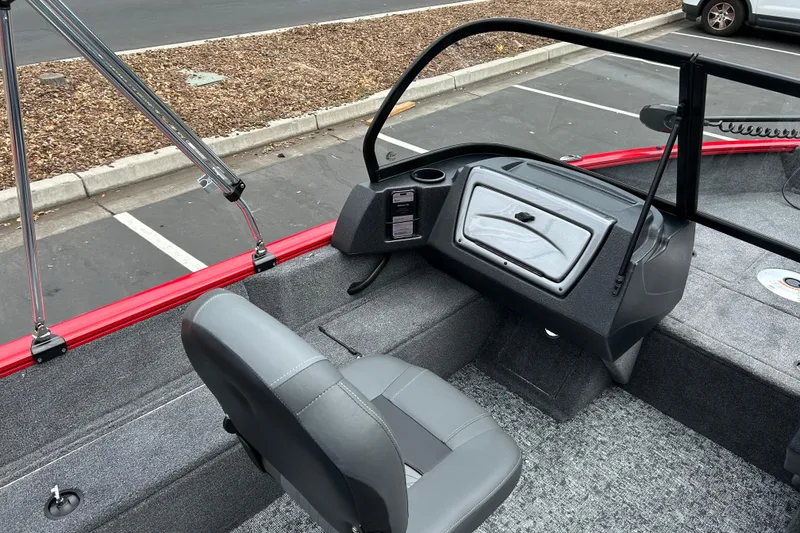Slide: The Image of 2026 Tracker Pro Guide V-16 WT boat interior with gray seating and red trim. - 8