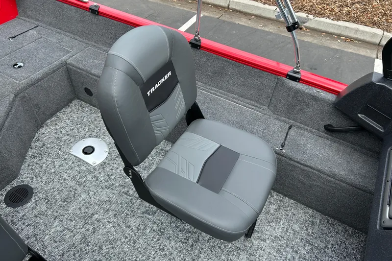 Slide: The Image of 2026 Tracker Pro Guide V-16 WT boat interior with gray seating and carpeted flooring. - 7