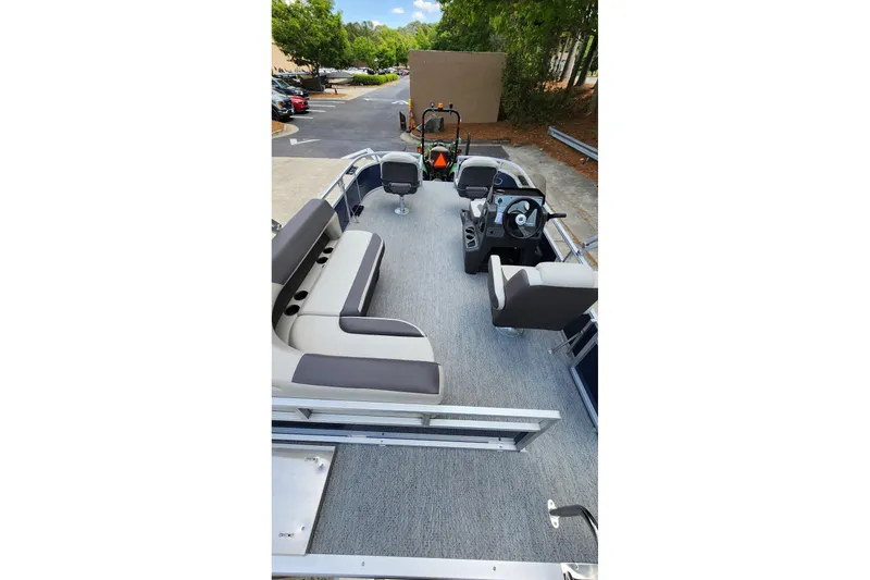Slide: The Image of 2026 Sun Tracker Bass Buggy 16 XL Select pontoon boat interior with seating and steering console. - 4