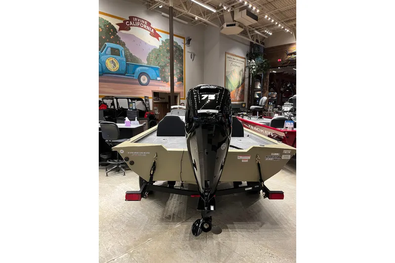 Slide: The Image of 2026 Tracker Pro Team 175 boat displayed indoors with motor, Irvine, California mural in background. - 5