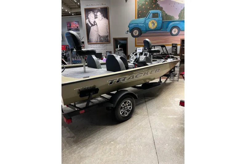 Slide: The Image of 2026 Tracker Pro Team 175 boat on display in a showroom with vintage decor. - 2