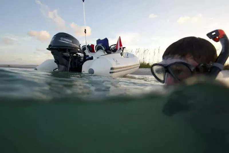 Slide: The Image of Snorkeler near Zodiac Yachtline 360 boat with Yamaha motor, 2026 model, in calm waters. - 4