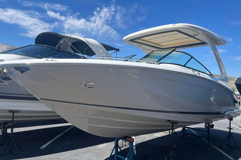 The Image of 2023 Regal 2800 Bowrider boat displayed outdoors under a clear blue sky. - 1