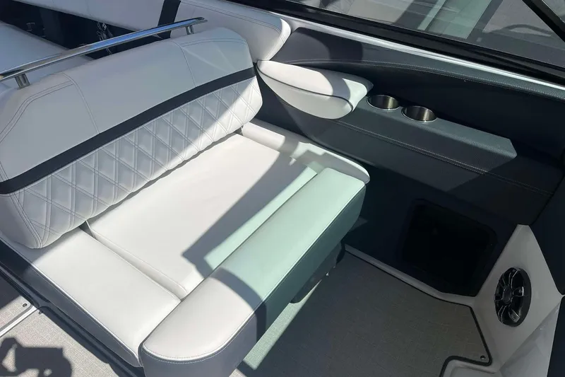Slide: The Image of 2023 Regal 2800 Bowrider interior with white seating and cup holders. - 13
