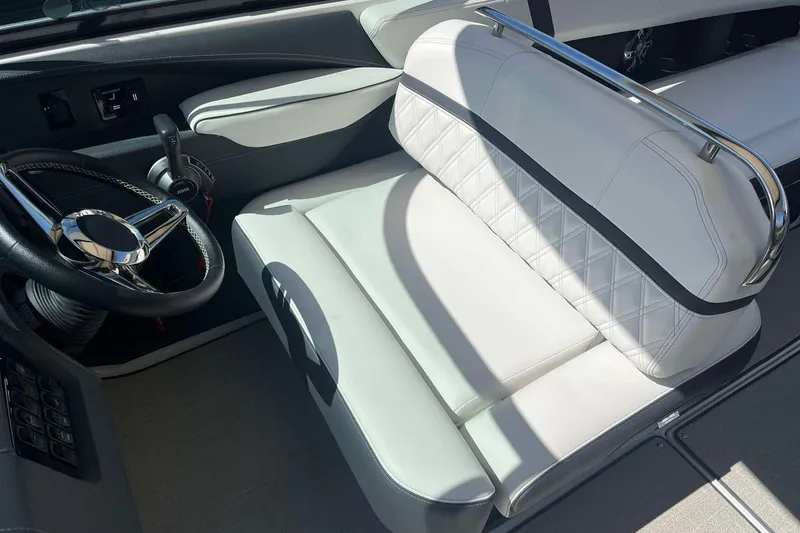 Slide: The Image of 2023 Regal 2800 Bowrider cockpit with luxurious white seating and sleek steering wheel. - 15