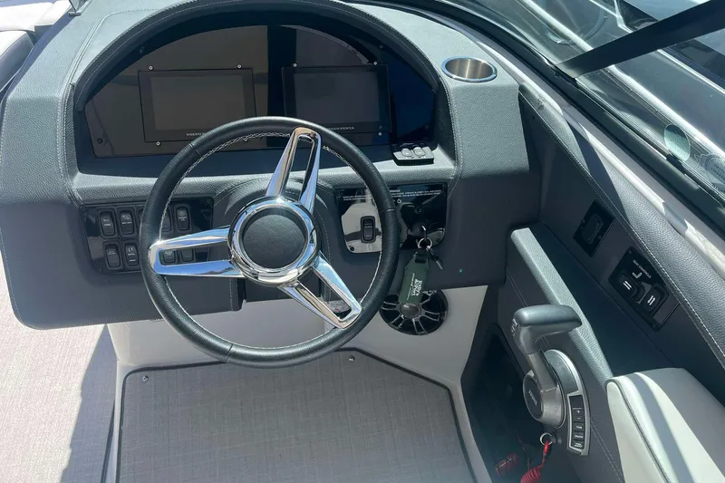 Slide: The Image of 2023 Regal 2800 Bowrider dashboard with steering wheel and control panel. - 16