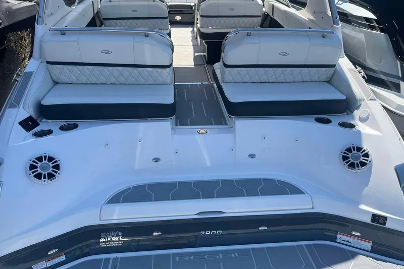 Slide: The Image of 2023 Regal 2800 Bowrider boat interior with cushioned seating and cup holders. - 22