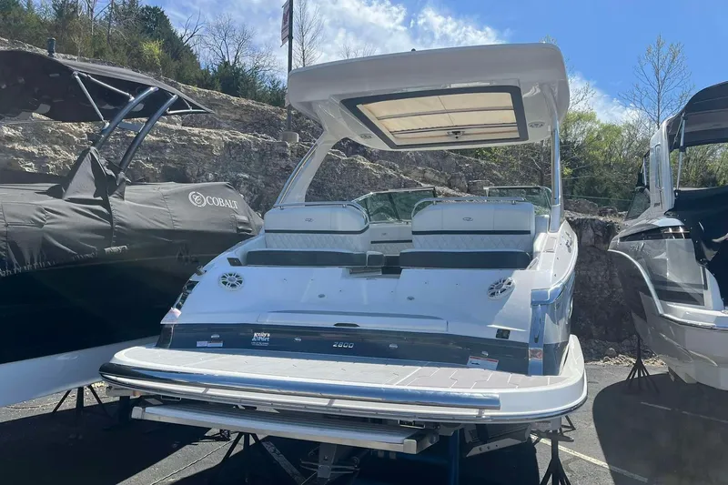 Slide: The Image of 2023 Regal 2800 Bowrider boat displayed outdoors, surrounded by other boats. - 4