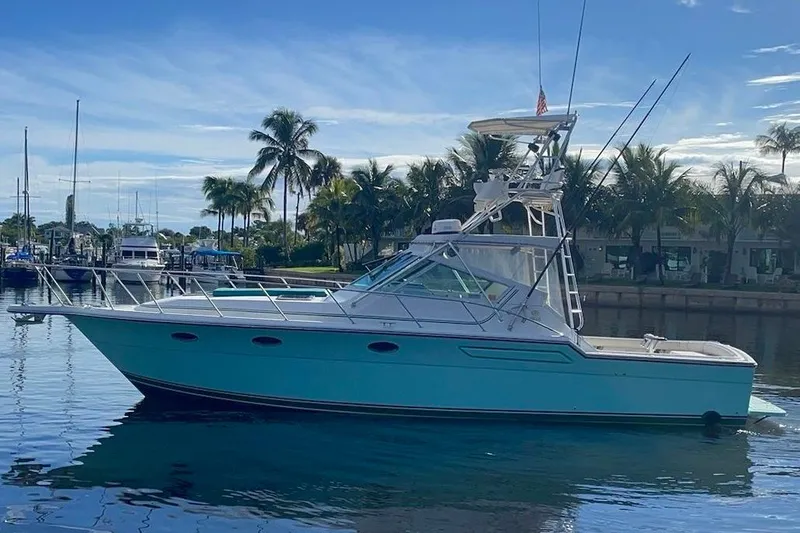 Slide: The Image of 1992 Tiara Yachts 3600 Open docked, featuring spacious deck and fishing equipment. - 1