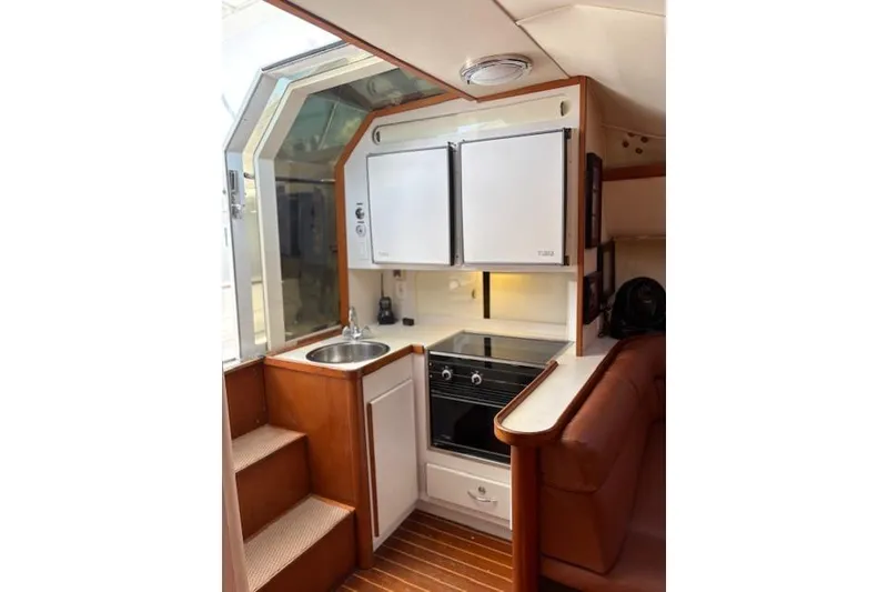 Slide: The Image of 1992 Tiara Yachts 3600 Open interior kitchen with stove, sink, and cabinetry. - 10