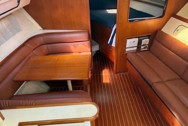 Slide: The Image of Interior of 1992 Tiara Yachts 3600 Open with wood accents and leather seating. - 13