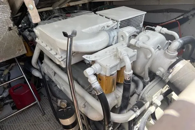 Slide: The Image of Engine compartment of a 1992 Tiara Yachts 3600 Open, showcasing mechanical components and hoses. - 17