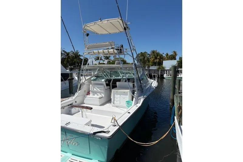 Slide: The Image of 1992 Tiara Yachts 3600 Open docked, showcasing spacious deck and fishing tower. - 2