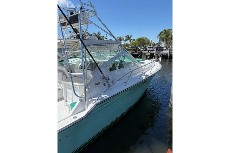 Slide: The Image of 1992 Tiara Yachts 3600 Open docked, featuring sleek design and clear blue skies. - 3