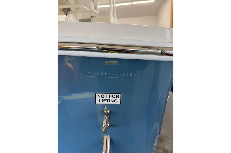Slide: The Image of 2017 Regulator 23 boat hull with "Not for Lifting" label and serial number. - 3