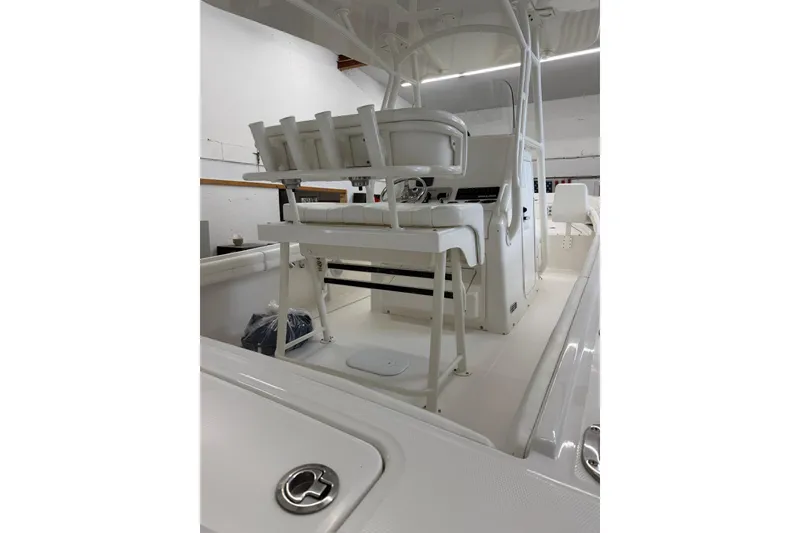Slide: The Image of 2017 Regulator 23 boat interior with seating and console in a showroom. - 4