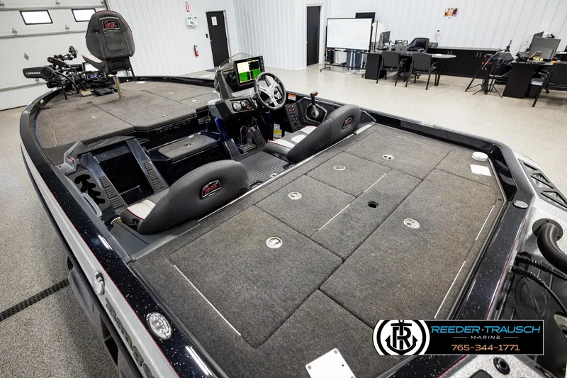 Slide: The Image of 2023 Ranger Z519 boat interior with advanced dashboard and seating in showroom. - 10