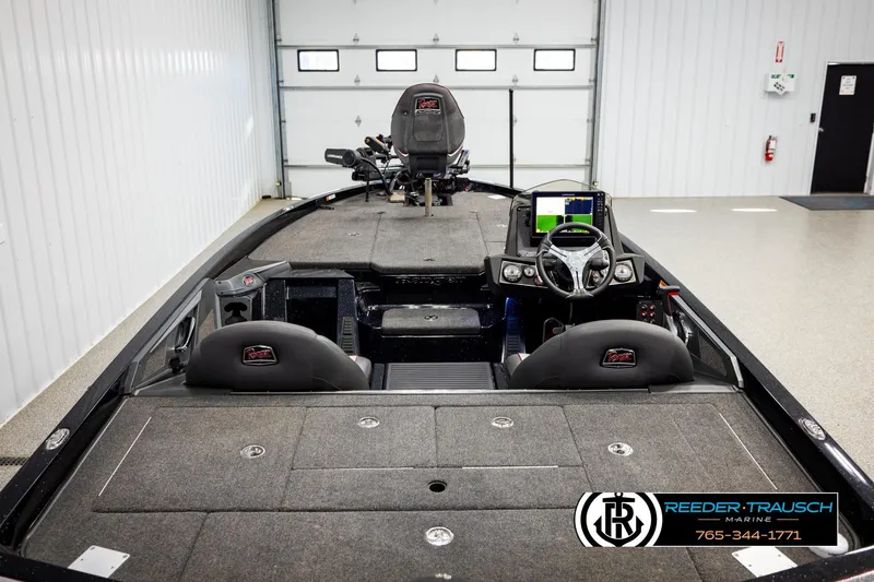 Slide: The Image of 2023 Ranger Z519 boat interior with steering console and seating in a showroom. - 12