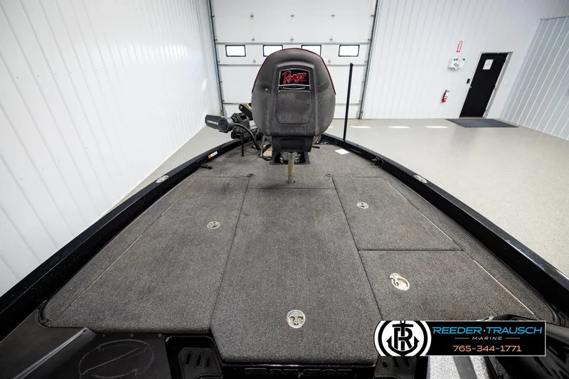 Slide: The Image of 2023 Ranger Z519 boat interior with carpeted deck and seat in a showroom. - 14