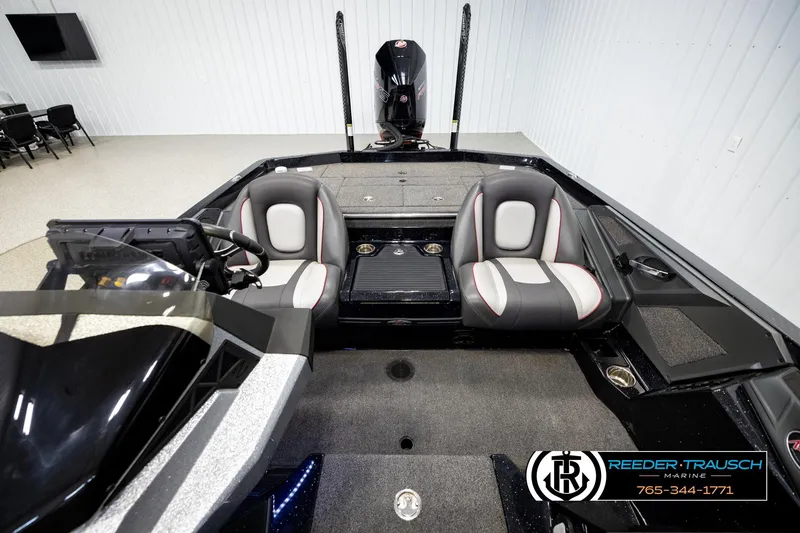 Slide: The Image of 2023 Ranger Z519 boat interior with dual seats and steering console in showroom. - 16