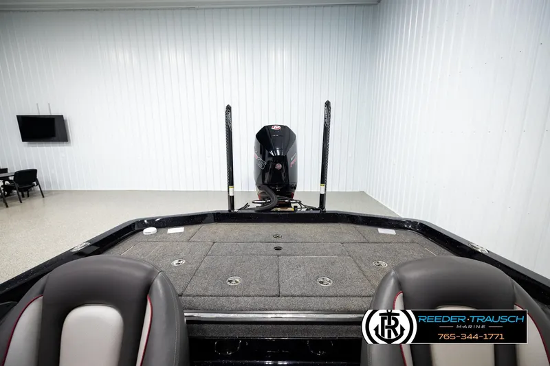 Slide: The Image of 2023 Ranger Z519 boat interior with motor, displayed in a showroom setting. - 17